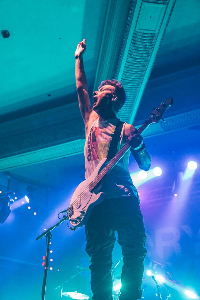 Adam, the bass player from Story of the Year throws his hand in the air